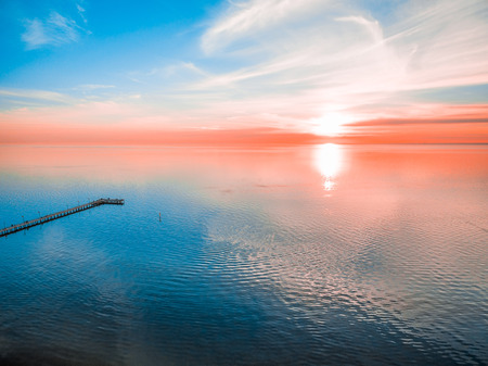 Glowing vivid red sunset over seaの写真素材