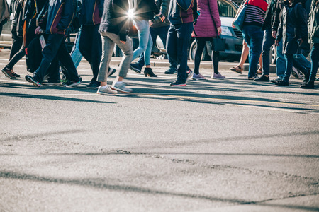Blurred motion of people legs crossing street in Melbourne CBD with copy spaceの写真素材