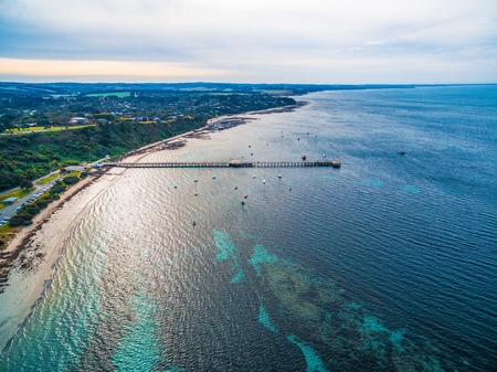 Aerial view of ocean coastline and pier in Flinders, Victoria, Australiaの写真素材