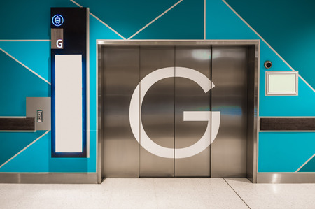 Closeup of elevator doors on ground floor of public building with copy spaceの写真素材