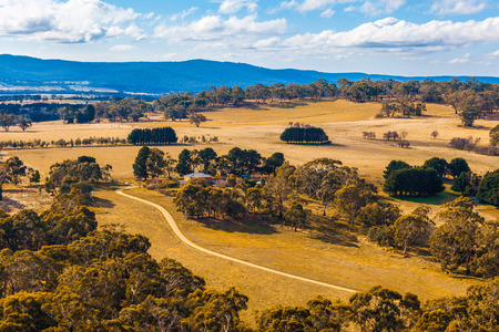 Scenic Australian countryside with winding dirt road. Macedon Ranges, Melbourne, Australiaの写真素材