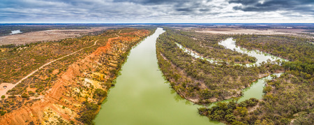 Aerial panorama of Murray River flowing into the horizon among gum trees in South Australiaの写真素材