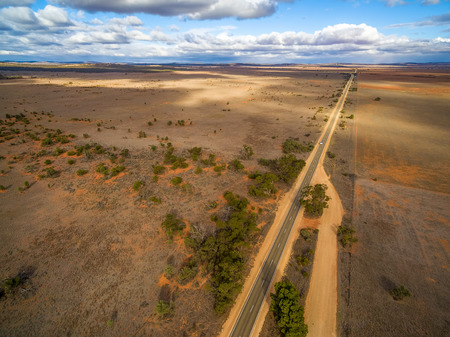 Straight rural highway passing through desert in South Australia - aerial viewの写真素材