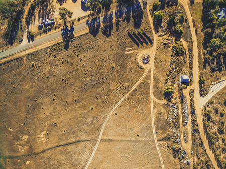Looking down at barren deserted land and dirt roads in South Australia - aerial viewの写真素材