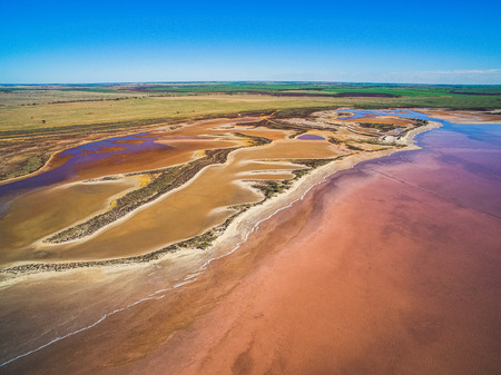 Aerial landscape of shallow salt lake and farmlands in Victoria, Australia