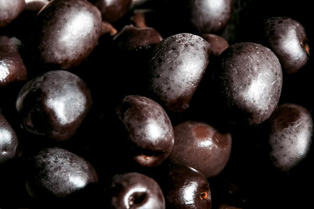 Black olives extreme closeup - grungy look