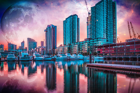 Alien fantasy landscape of the future - high rise buildings and moored yachts with huge alien planet in the sky reflecting in water. Elements of this image are furnished by NASAのeditorial素材