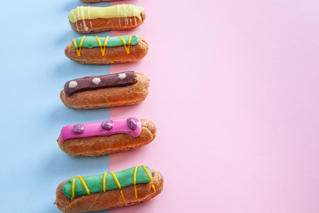 Eclairs on pink-blue background with copy spaceの写真素材