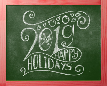 Happy Holidays 2019 chalk lettering on green chalkboardの写真素材