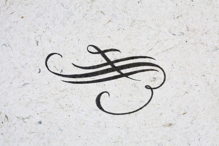 Elegant coppeplate flourish - ink on kraft paperの写真素材