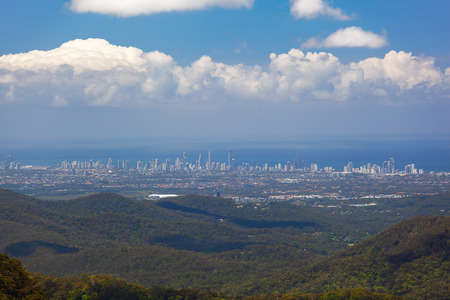 Beautiful green hills with Gold Coast skyscrapers in the distance on bright summer day. Queensland,...