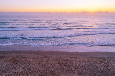Sunrise over empty ocean beach with copy spaceの写真素材