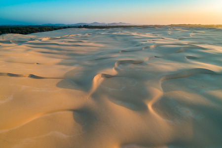 Scenic sand dunes and hills at sunset - aerial viewの写真素材