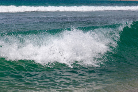 Closeup of breaking wave with another wave in the backgroundの写真素材