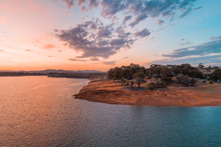Aerial view of Lake Hume coastline in the beautiful orange glow of twilight timeの写真素材