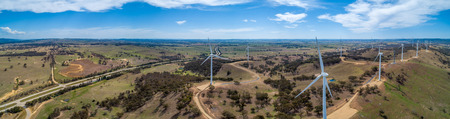 Wide aerial panorama of Hume Highway and wind farm in beautiful Australian countryside. Breadalbane, NSW, Australiaの写真素材