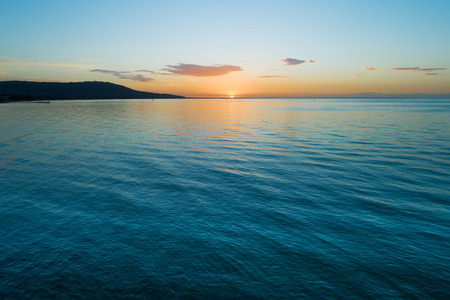 Water and land at dusk - minimalist aerial seascapeの写真素材