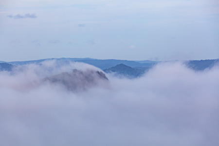 Clouds covering forested hills with copy spaceの写真素材
