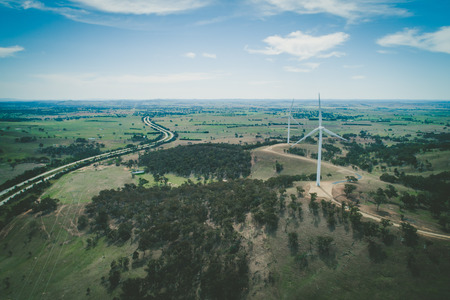 Wind turbines and rural highway in scenic countryside - aerial viewの写真素材