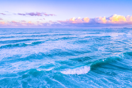 Crushing ocean waves at vivid sunriseの写真素材