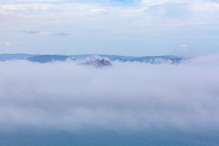 Low clouds over ocean and islands with copy spaceの写真素材