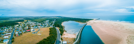 Wide aerial panorama of Harrington township and ocean coastline. Harrington, New South Wales, Australiaの写真素材