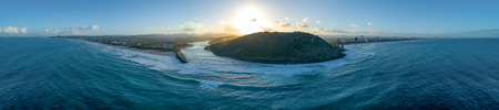 Wide aerial panorama of Tallebudgera creek mouth, Burleigh Head National Park, and coastline at sunset. Gold Coast, Queensland, Australiaの写真素材
