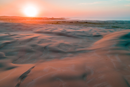 Aerial view of pristine sand dunes at sunriseの写真素材