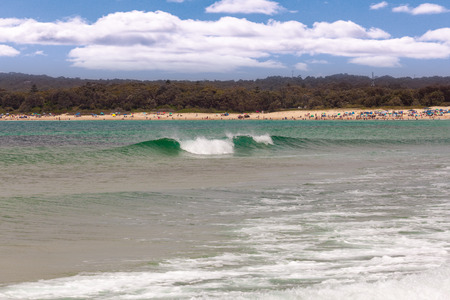 Ocean waves and bathing people at Fingal Bay beach, New South Wales, Australiaの写真素材