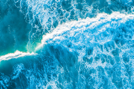 Vivid blue crushing wave at sunset. Aerial view with copy spaceの写真素材