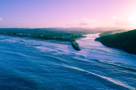 Aerial view of Tallebudgera creek mouth and ocean coastline at sunset. Gold Coast, Queensland, Australiaの写真素材