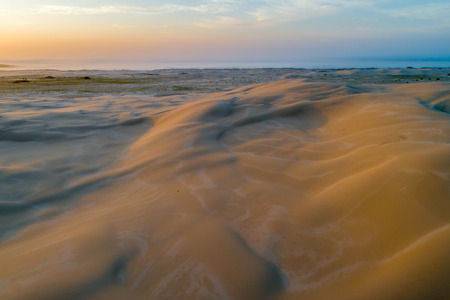 Scenic sand dunes near the ocean at sunrise. Anna Bay, New South Wales, Australiaの写真素材