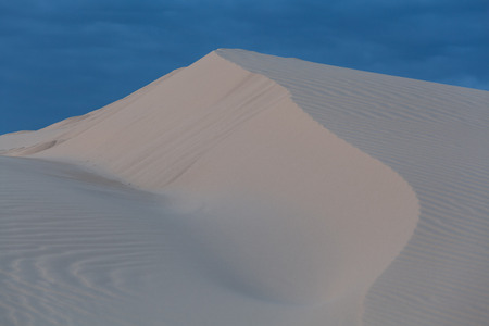 Closeup of a ridge on white sand dune in Australiaの写真素材
