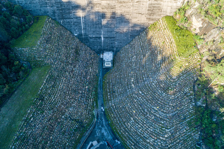 Looking down at Nepean Dam wall and power lines - aerial view. Bargo, New South Wales, Australiaの写真素材