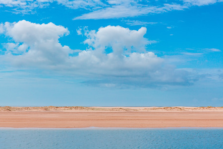 Minimalist landscape - stretch of sand between water and skiesの写真素材