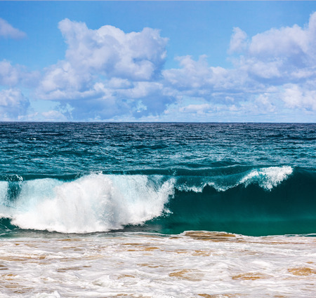 Beautiful clouds and breaking ocean waveの写真素材