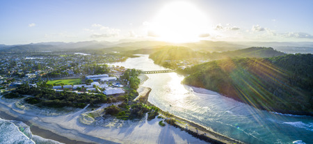 Aerial panorama of sunset with sun flare over Tallebudgera creek in Gold Coast, Queensland, Australiaの写真素材