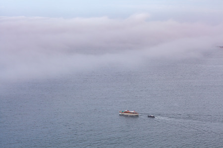 Two Boats sailing under low clouds - mysterious seascapeの写真素材
