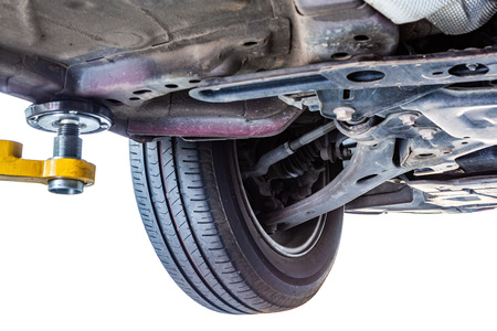 Closeup of car undercarriage lifted on hydraulic liftの写真素材