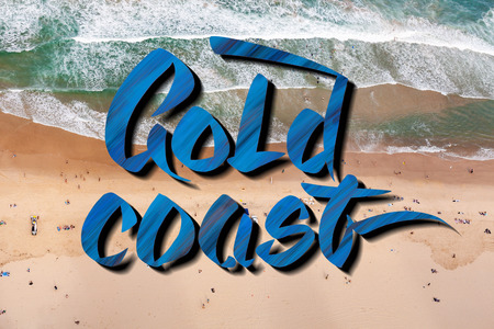 Gold coast lettering over aerial view of people on the beach in Queensland, Australia