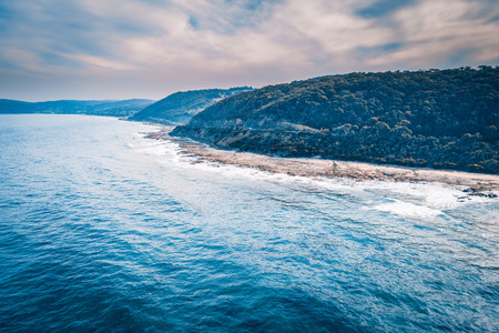 Forested hills over ocean coastline. Great Ocean Road, Victoria, Australiaの写真素材