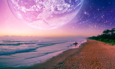 Fantasy landscape of surfer silhouette  walking on the beach of alien planet.の写真素材