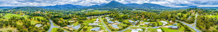 Wide aerial panorama of scenic countryside with houses surrounded by forest and mountains. Healesville, Victoria, Australiaの写真素材