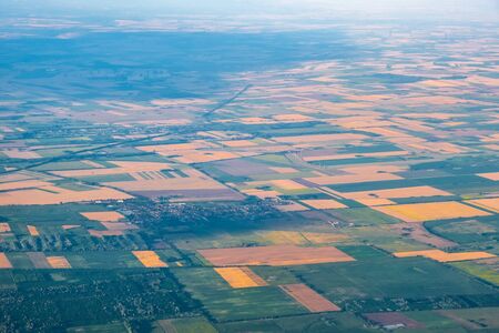 Aerial view of agricultural land patchwork crops in hazy atmosphereの写真素材