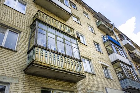 Old soviet style brick building with decaying balconiesの写真素材