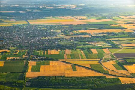 Aerial view of rural area and agricultural fields crossed by highways at sunsetの写真素材