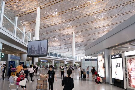 Beijing, China - June 17, 2019: People walking at international departures terminal at the airportのeditorial素材