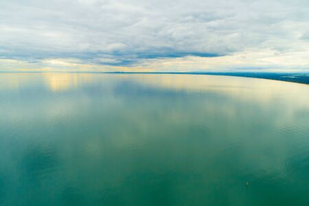 Sunset over Port Phillip Bay on a cloudy day in Melbourne, Australiaの写真素材