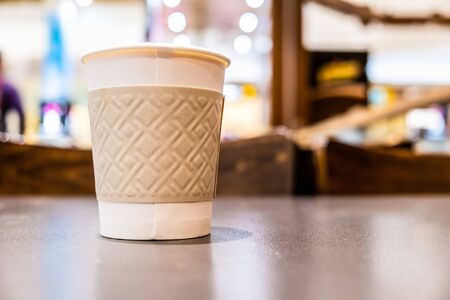 Plastic coffee cup closeup on blurred background with copy spaceの写真素材