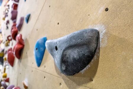 Extreme closeup of black climbing gym hold on blurred backgroundの写真素材